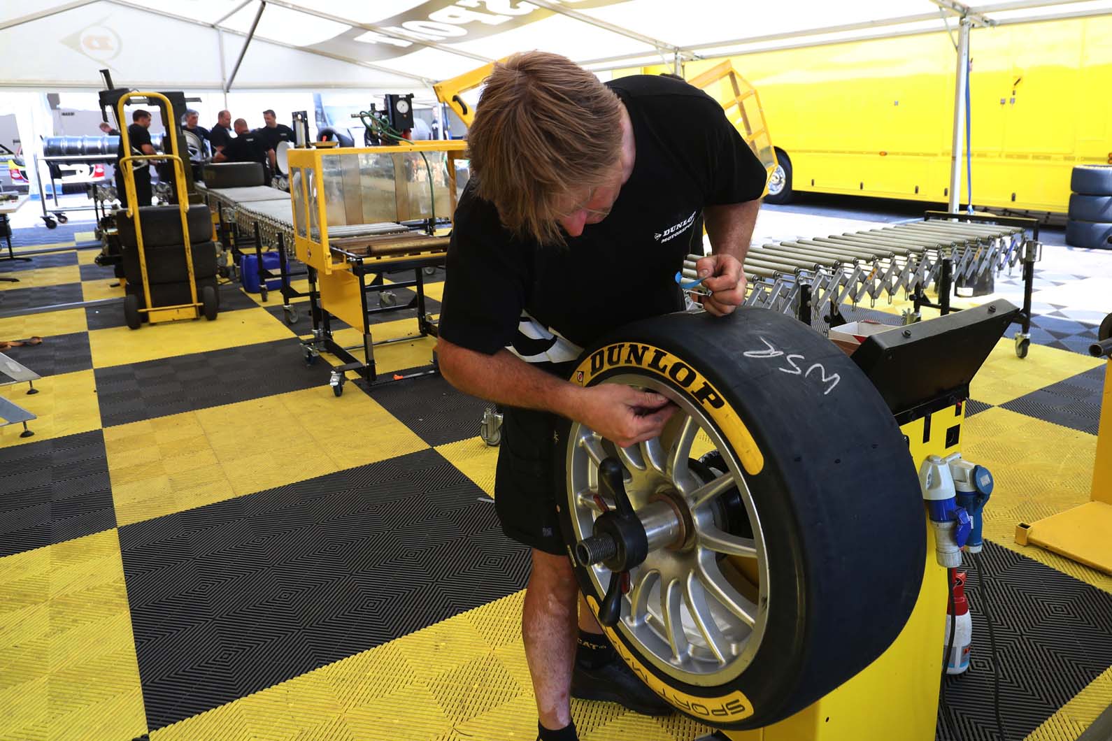 Dunlop fitter balances tyres before being dispatched to the team