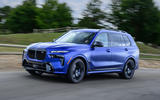 BMW X7 driving three quarters side